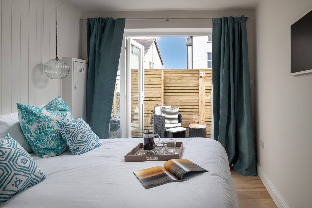 A double bedroom overlooking the outdoor seating area
